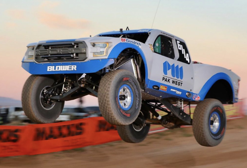 Blower Motorsports truck suspended in the air after going off a jump