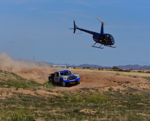 Blower Motorsports truck tracking dust with a helicopter chasing